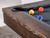 A close-up shot of the Nora Slate Pool Table in Brown Wash, featuring billiard balls near the corner pocket. The table is shown with the included premium accessories kit: pool balls, a ball rack, four cue sticks, a table brush, and chalk. Designed for both gameplay and aesthetic appeal, this table is ready for use right out of the box. Available at Sawyer Twain with free shipping USA.

