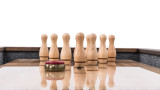 Pins arranged for play on a styled shuffleboard table in a home game room setting