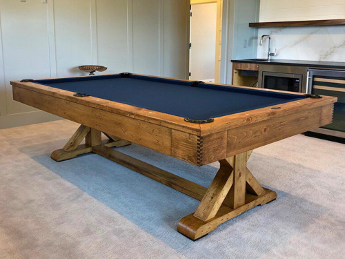 Angled in-room view of the Hepburn Slate Pool Table by Doc & Holliday set up in a modern farmhouse interior, highlighting its rich Dark Burl finish and seamless blend with upscale, relaxed home decor.