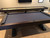 Otis Slate Pool Table and matching Otis Shuffleboard Table by Plank & Hide, displayed side by side in a professionally designed basement bar, showcasing their Smokehouse finish, X-style legs, and cohesive modern farmhouse aesthetic in a complete game room environment