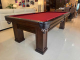 Close-up angle of the Brunswick Oakland Pool Table showcasing espresso wood grain, pedestal legs, and leather drop pockets with braided accents | Sawyer Twain.