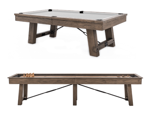 The Isaac Pool Table and Shuffleboard Table shown together in matching Silvered Ash finish. The coordinated industrial design, brushed hardware, and sand-washed tones make a strong visual statement for any high-end game room.