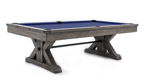 The Otis Slate Pool Table showcases a stunning farmhouse-contemporary design in either Weathered Grey or rich Brown. Crafted from solid Douglas Fir with a carefully distressed finish, this piece features a bold ‘X’ trestle base with industrial metal accents and genuine leather drop pockets, making it a striking centerpiece for any modern home.